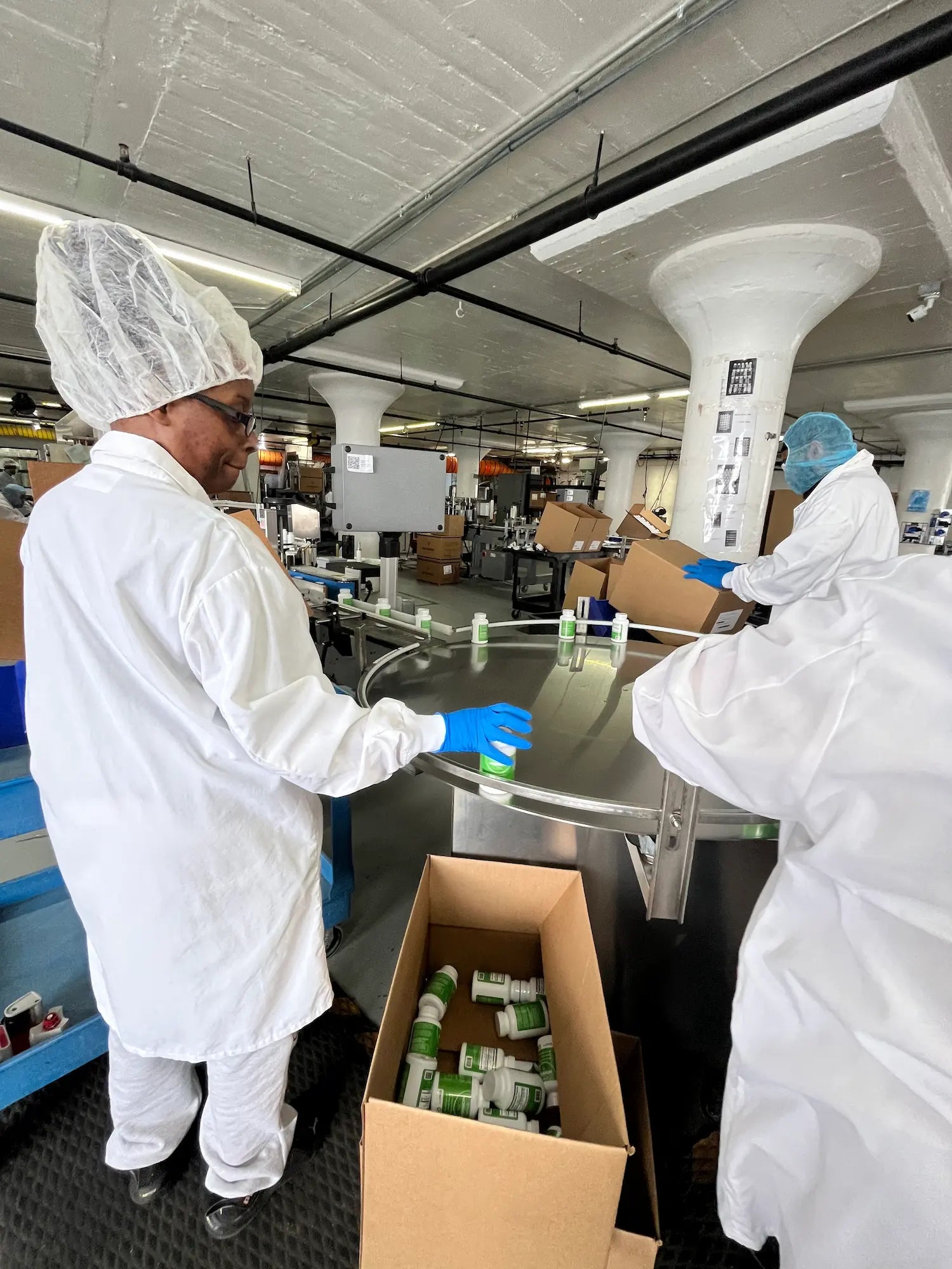 Rosabella bottles being packed by hand at the manufacturing facility